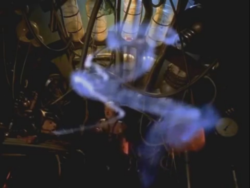 a man's head on a table with blue smoke swirling out of his mouth into a machine.